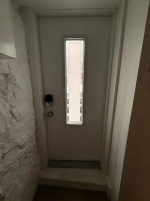 a hallway with a window and a door at Lower level newly renovated studio apartment in central downtown location in Toronto