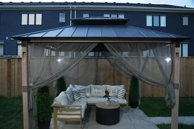 a large gazebo with a couch under it at JNShortStay- Niagara Falls Area Hidden Gem in Welland