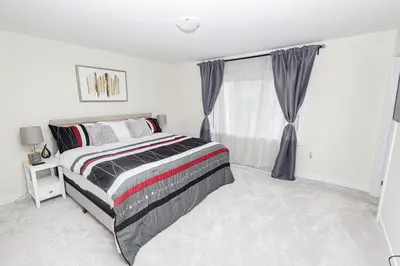 a bedroom with a bed and a window at JNShortStay- Niagara Falls Area Hidden Gem in Welland