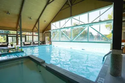 a large swimming pool with a large window at Stunning Condo with Access to Pool in Shanty Bay