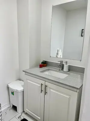 a white bathroom with a sink and a mirror at K1 Private Bathroom Queen Bed Room in Mississauga