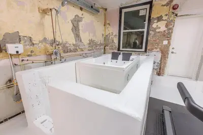 a bathroom with a white sink and a mirror at Renovated Church Hamilton! Guest Suite in Hamilton