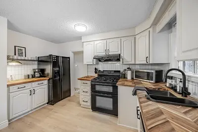 a kitchen with white cabinets and stainless steel appliances at Unique Oasis with Tri-City Access in Mississauga