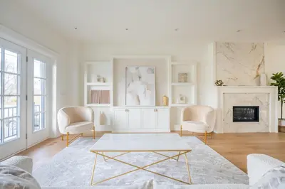 a living room with a table and chairs and a fireplace at Luxury Home - 5 min from airport, 15 to downtown in Toronto
