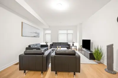 a living room with two couches and a tv at SPRUCE Private Suite with attached Full Bathroom in Toronto, Canada in Toronto