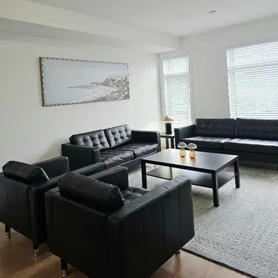 a living room with black furniture and a table at Private Room M A P L E with Attached Full Bathroom in Toronto, ON, Canada in Toronto