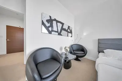 a living room with two black chairs and a couch at RentX 3Bedroom Penthouses near Rogers Centre & MTCC in Toronto