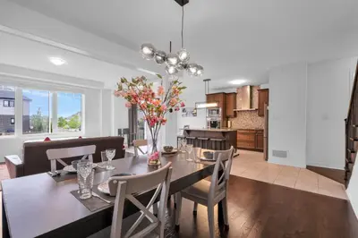 a dining room and kitchen with a table and chairs at Entire 6BR 2 king 8 beds in total pets 3 GB WiFi in Kitchener