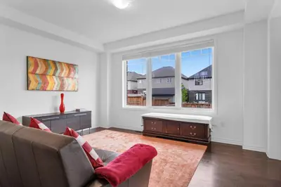 a living room with a couch and a large window at Entire 6BR 2 king 8 beds in total pets 3 GB WiFi in Kitchener