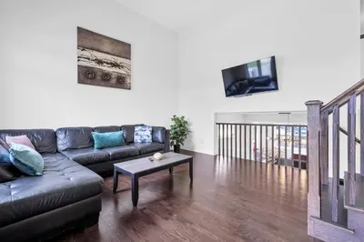 a living room with a couch and a table at Entire 6BR 2 king 8 beds in total pets 3 GB WiFi in Kitchener