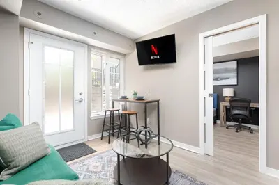 a living room with a couch and a table at Lakeside Haven - Cozy Townhome in Liberty Village in Toronto