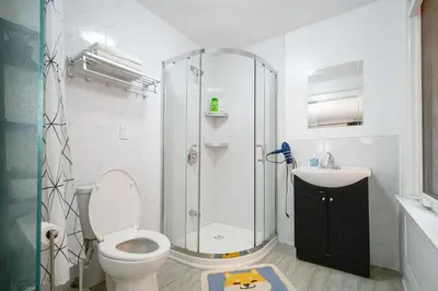 a bathroom with a shower and a toilet and a sink at Spacious Room with Ensuite Bathroom near Subway, Koreatown & UofT in Toronto