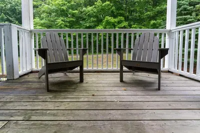 two chairs sitting on top of a porch at King Bed, Balcony, Pool, Hot Tub, Sauna in Edgar