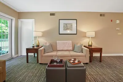 a living room with a couch and a table at King Bed, Balcony, Pool, Hot Tub, Sauna in Edgar