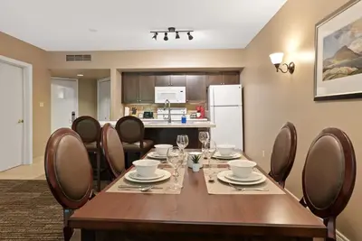 a dining room with a wooden table and chairs at King Bed, Balcony, Pool, Hot Tub, Sauna in Edgar