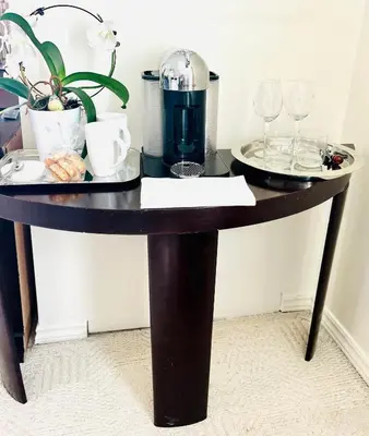 a table with glasses and a coffee maker on it at Hummingbird Haven Bed & Breakfast Luxury Suite With Terrace & Seasonal Lake Views Located in Historic Old Town Niagara-On-The-Lake in Niagara on the Lake