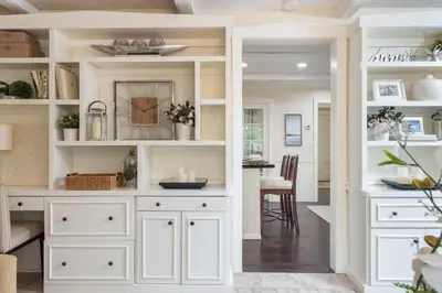 a kitchen with white cabinets and a dining room at Hummingbird Haven Bed & Breakfast Luxury Suite With Terrace & Seasonal Lake Views Located in Historic Old Town Niagara-On-The-Lake in Niagara on the Lake