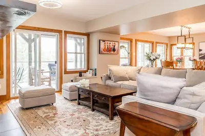 a living room with a couch and a table at Muskoka Lakeshore Cottage Bliss in Gravenhurst