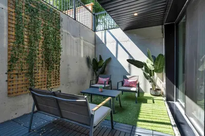 an outdoor patio with two chairs and a table at Hidden Gem - 3 BR Steps to Little Italy and UofT in Toronto