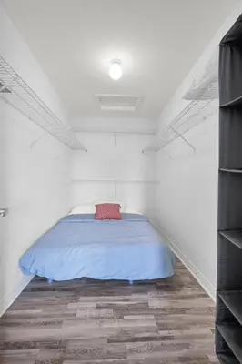 a bedroom with a bed in a white room at 4BR 2 king 3 Queen 6 beds in total 3 GBPS Wi-Fi in Kitchener