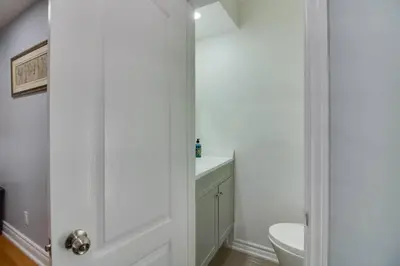 a bathroom with a white toilet and a sink at Beautiful house near Eglinton GO in Toronto