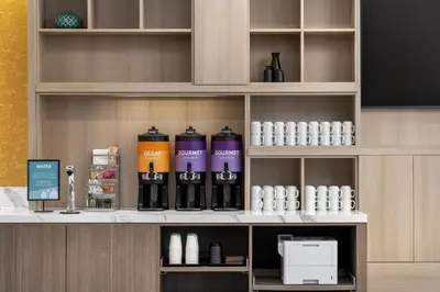 a shelf with bottles of wine on it at Home2 Suites By Hilton Woodstock On in Woodstock