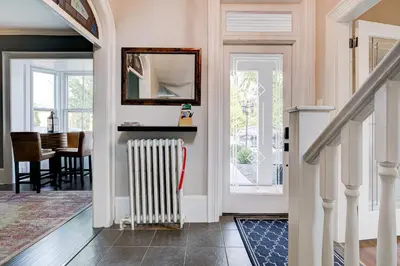 a hallway with a radiator and a dining room at Historic Home in the Heart of Elora in Elora