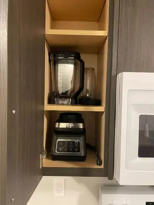 a coffeemaker is sitting inside of a cabinet at Modern, well-equipped, and centrally located in Fonthill