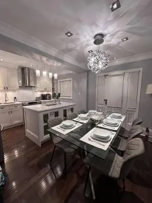 a dining room with a table and chairs in a kitchen at Leaside Rental with Great Backyard & Pool in Toronto