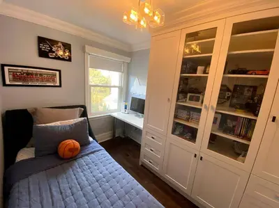 a bedroom with a bed with a basketball on it at Leaside Rental with Great Backyard & Pool in Toronto