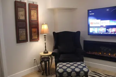 a living room with a chair and a flat screen tv at Luxurious Private Apartment in Oakville