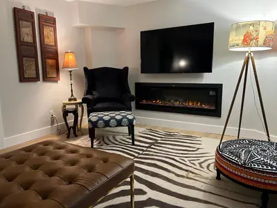 a living room with a couch and a fireplace at Luxurious Private Apartment in Oakville