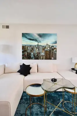 a living room with a white couch and two tables at Lux Jacuzzi Suite - Top Level in Shanty Bay