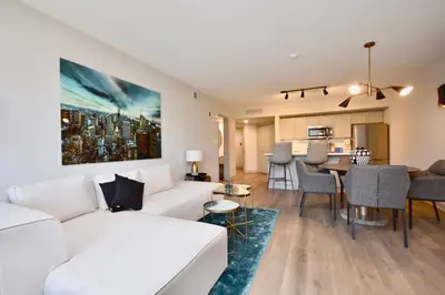 a living room with a white couch and a table at Lux Jacuzzi Suite - Top Level in Shanty Bay