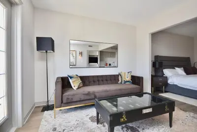 a living room with a couch and a bed at Relaxing Top Level Studio in Edgar