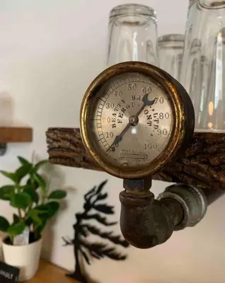 a clock sitting on top of a table at Stone Mill Retreat - Rustic Cozy Getaway with Loft! in Fergus