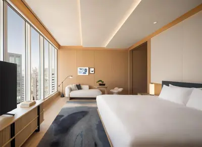 a bedroom with a large white bed and a couch at Nobu Hotel Toronto in Toronto