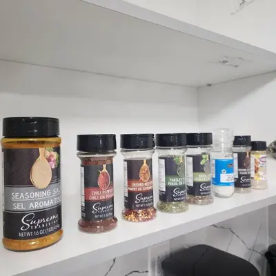 a shelf with several jars of spices on it at Cozy Hideaway in Thorold