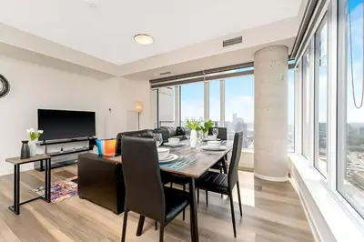 a dining room with a table and chairs at Newly Built Condo with Amazing Views in Kitchener