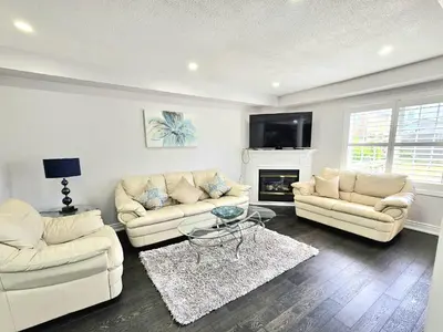 a living room with two couches and a fireplace at Beautiful 3 bedroom Entire detached home in Whitby