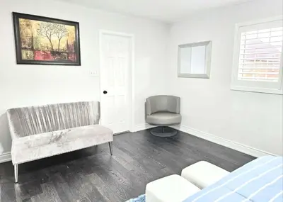 a bedroom with a couch and a chair and a window at Beautiful 3 bedroom Entire detached home in Whitby