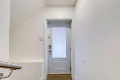 a hallway with a white door in a room at Midtown 2 Bedroom Apartment in Toronto