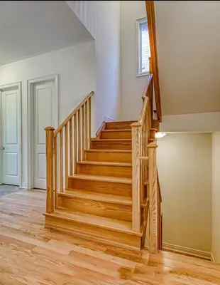 a staircase in a home with wood floors at Bright bedroom with private bathroom in Richmond Hill