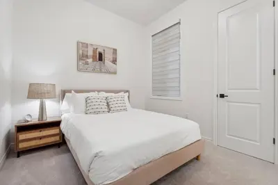 a white bedroom with a bed and a window at Luxury Vacation Home Near Lake Pool Table in Barrie