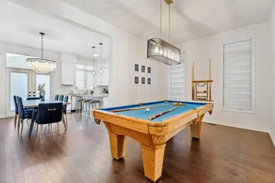 a living room with a pool table and a kitchen at Luxury Vacation Home Near Lake Pool Table in Barrie