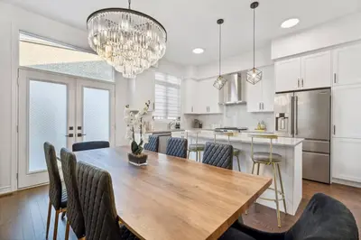 a kitchen and dining room with a wooden table and chairs at Luxury Vacation Home Near Lake Pool Table in Barrie