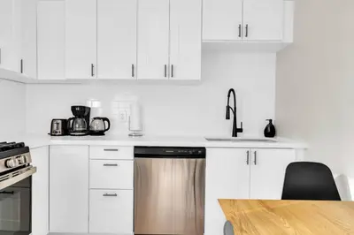 a kitchen with white cabinets and a stainless steel dishwasher at RentX 3Bed Cozy Home - Hospital GO 2ParkingWi-Fi in Hamilton