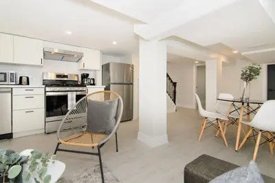 a kitchen and living room with chairs and a table at RentX Modern Suite - Near GO Hospital Parking in Hamilton