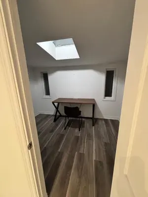 an empty room with a table and a skylight at Entire bungalow, full privacy, free parking in Oshawa