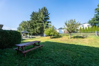 a picnic table in the grass in a park at Chic and Cozy 5 Bedroom House in Brampton